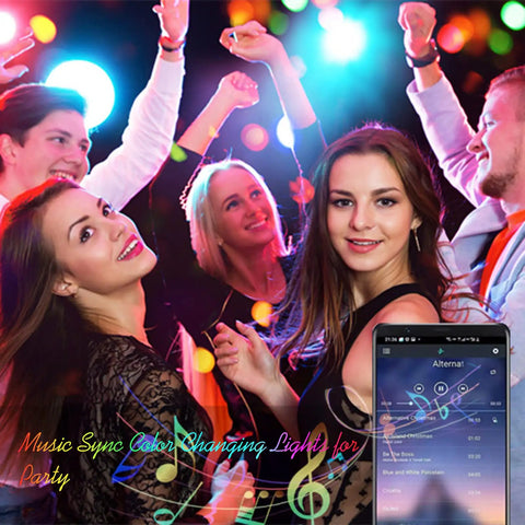 Group of friends dancing under 100ft LED Strip Lights For Bedroom And Living Room With App Control And Music Sync RGB Color Changing LEDs Remote For Party Vibe