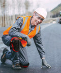 Man wearing Knee Pads For Work With Soft Gel Core And EVA Foam Padding, ergonomic cushion for comfort, kneeling on road