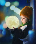 Child holding Moon Lamp 7 Inch 3D Printed Moon Light With Stand, 16 Color LED Night Light glowing softly in the night