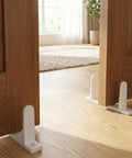 Four Pack Sliding Closet Door Floor Guide Set Built To Last With Universal ABS Bottom Guides Fit One And Three Eighths Inch Doors Complete Track Kit With Screws For Easy No Fuss Cabinet Installation White installed on wood closet door