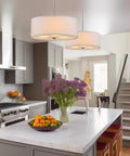 Three Light Drum Pendant Chandelier With White Fabric Shade Brushed Nickel Finish Tempered Glass Diffuser above kitchen island