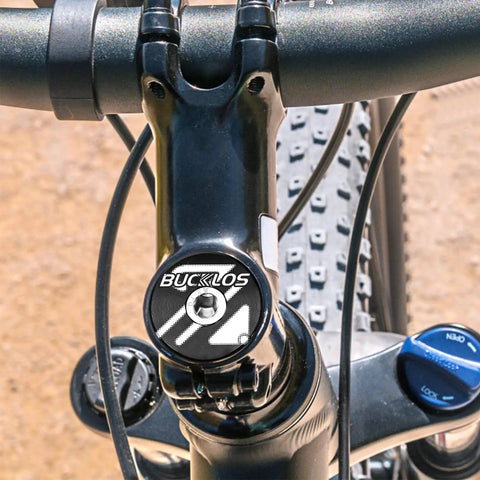 Close-up of a bike headset top cap kit for 1-1/8 inch forks with aluminum alloy construction and steel bolt on handlebars.