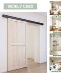 6Ft Barn Door Hardware Kit With Low Clearance Aluminum Box Rail Track System for interior doors installed in a living room.