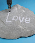 Carving tool etching 'Love' on stone, using 10 Pcs Carbide Burr Set With 1/4 Inch Shank In Red Box Beefy Pro Grade Die Grinder Bits Kit