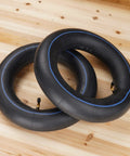 Pair of 3.25/3.00-8 Inner Tubes With TR-87 Angled Stem for 8 Inch Rims on wooden floor