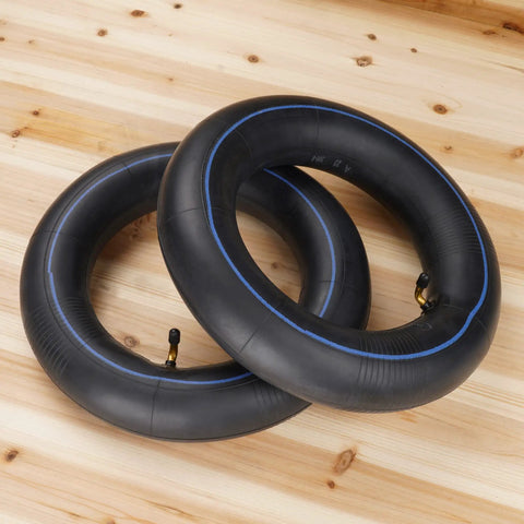 Pair of 3.25/3.00-8 Inner Tubes With TR-87 Angled Stem for 8 Inch Rims on wooden floor