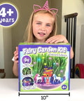 Girl holding Unicorn Fairy Garden Kit With Light Up Terrarium For Girls Ages 4 To 12, STEM Toys And Arts And Crafts Gift box