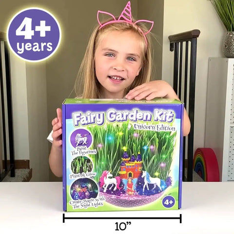 Girl holding Unicorn Fairy Garden Kit With Light Up Terrarium For Girls Ages 4 To 12, STEM Toys And Arts And Crafts Gift box