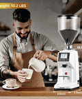 Premium 64Mm Commercial Electric Coffee Grinder With Stainless Steel Flat Burrs And Smart Touchscreen Setup To Easily Crush Beans And Dial In Your Daily Brew Like A Pro In Clean White Finish on cafe counter with coffee preparation.