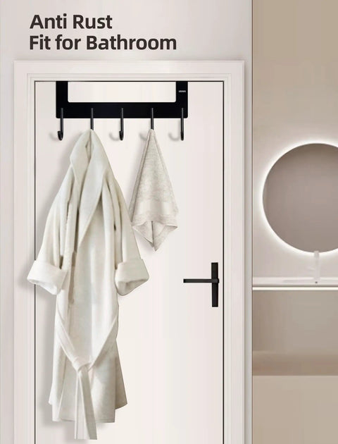 Over The Door Towel Rack With 5 Heavy Duty Aluminum Hooks For Towels Coats Robes Bags Hats Space Saving Door Hanger Matte Black Finish Durable Easy Install, holding a robe and towel.