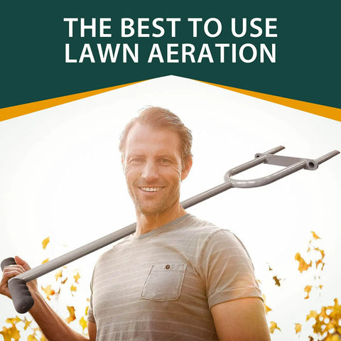 Man holding Lawn Core Aerator Tool Manual Dethatching And Soil Aeration Heavy Duty Garden Aerator against fall foliage background.