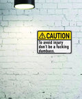 Dont Be A Dumbass Caution Tin Sign 12 By 8 Inches Funny Metal Wall Decor For Office Cubicle Breakroom Garage Shop Man Cave Home Bar Pub Durable Tin Metal Quality Indoor Use on white brick wall