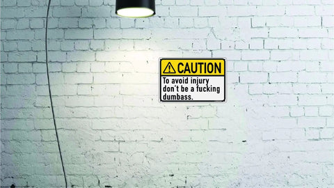 Dont Be A Dumbass Caution Tin Sign 12 By 8 Inches Funny Metal Wall Decor For Office Cubicle Breakroom Garage Shop Man Cave Home Bar Pub Durable Tin Metal Quality Indoor Use on white brick wall