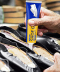 Close-up of person applying Clear Shoe Glue For Soles And Heels Repair Waterproof Adhesive For Sneakers Boots Leather Bags Quick Dry