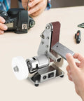 Rugged Mini Belt Sander And Auto Knife Sharpener Buffer Gear With Badass 150 Watt Copper Motor, used on metal piece.