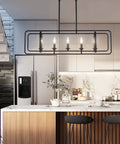 Modern Farmhouse 5 Light Kitchen Island Pendant Chandelier In Black Metal, Adjustable Rotatable Frame installed over kitchen island.