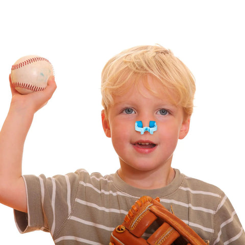 Blue plastic nose clip for stopping nosebleeds worn on the nose by a child; baseball glove visible.