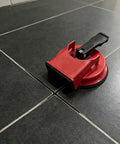 DIY Easy Grip Suction Cup Floor Repair Tool for quick fixes at home without pros, black tile floor, durable ABS and rubber build.
