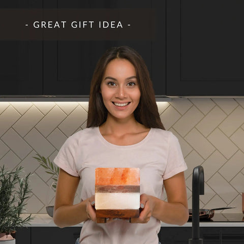 Woman holding Dual Illumination Himalayan Salt Rock Lamp with Real Pink White and Grey Salt Block Dimmer Control in kitchen.