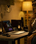Man in home studio with HS4 Black Powered Studio Monitors Pair With 4.5 Inch Woofer And 1 Inch Dome Tweeter 60 Hz To 22 kHz 26W Output