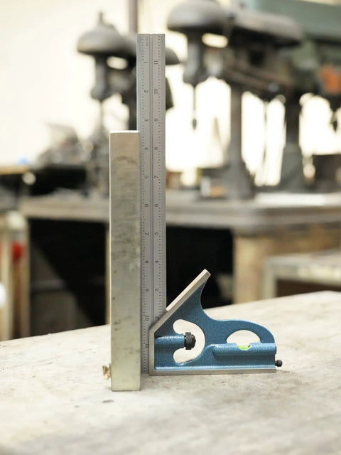 2-Piece 6-Inch Machinist Combination Square With Cast Iron Head 4R, Level Vial, And Scribe Tool on a workbench