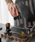 Person using All In One Dope Espresso Tamping Station With Distributor And Tamper Holder Including Tamping Mat And Milk Pitcher Mat Fits 51mm 53mm 54mm 58mm Portafilters Wooden Gold Finish Coffee Accessories Easy Access Stand.