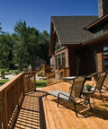 Wooden deck with outdoor chairs, showcasing construction possibly using Structural Wood Screw Set for Exterior Projects.