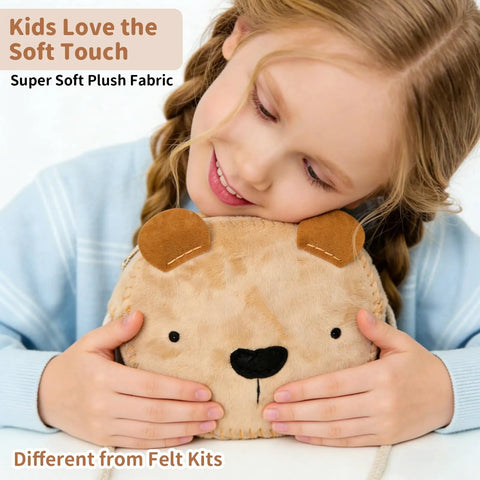 Child holding Little Bear DIY Sewing Kit For Beginners Kids Arts And Crafts Plush Crossbody Bag With Zipper, smiling and hugging plush bear bag.