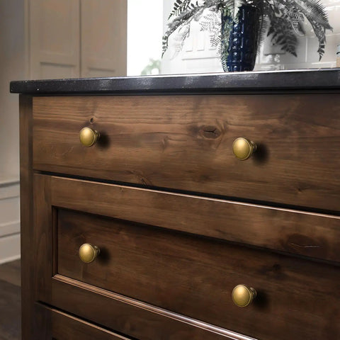 Antique Brass Cabinet Knobs 6 Pack Zinc Alloy Drawer Pulls installed on wooden dresser for kitchen or furniture use