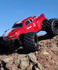 Volcano One Sixteenth Scale RC Monster Truck with Four Wheel Drive climbing rocky terrain