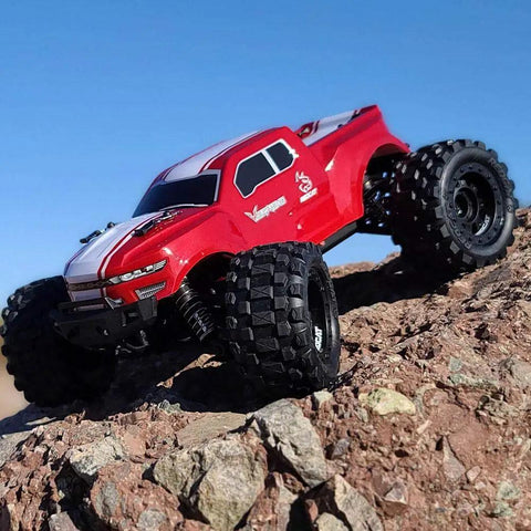 Volcano One Sixteenth Scale RC Monster Truck with Four Wheel Drive climbing rocky terrain