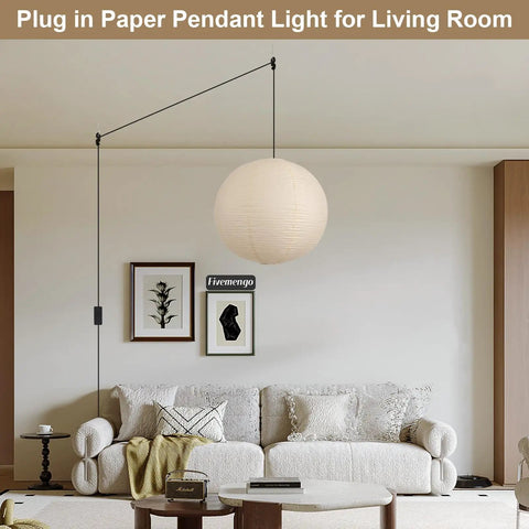 Twenty Inch Off White Japanese Rice Paper Lantern Plug In Pendant Light With Adjustable Cord Sets hanging above a cozy living room couch.