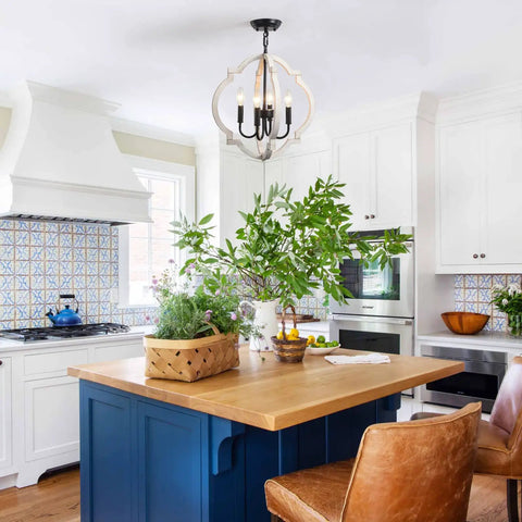 Farmhouse Orb Wood Chandelier 4 Light Pendant illuminating a rustic kitchen with blue island and leather chairs.