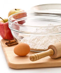Glass bowl with flour beside apples, egg, and rolling pin on cutting board - Flour Keeper Airtight Storage Container For Flour Sugar And Dry Goods 5 Lb Capacity BPA Free Easy Pour Design Built In Leveler For Precise Measuring And Pantry Organization Go To Kitchen Essential