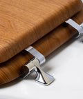 Close-up of natural oak veneer toilet seat with chrome hinges, elongated fit, showing the durable wood look and easy-to-clean finish.