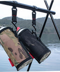 Two water bottles secured on a pole with S Shaped Movable Strap Hooks from Five Piece Large Outdoor Camping Hook Set by a lake