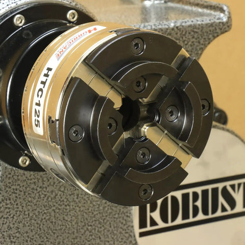 Close-up of the HTC125 5 Inch Four Jaw Woodturning Chuck Kit with dovetail jaws on a wood lathe.