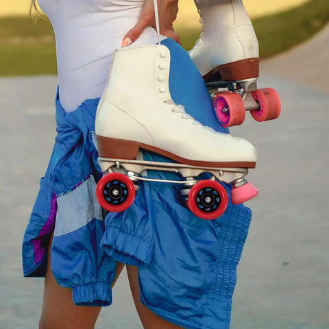 Person holding white blue skates with Replacement Roller Skate Wheels Red 92A Quad Skateboard Wheels High Hardness