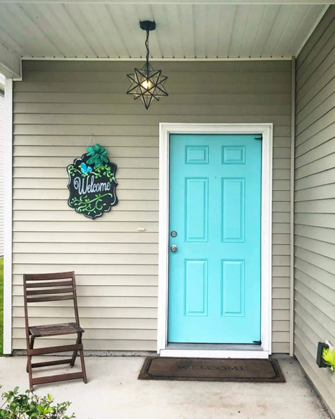 Front porch with Moravian Star Pendant Light With Seeded Glass Shade, Adjustable Chain, 16 Inch Diameter, above turquoise door.