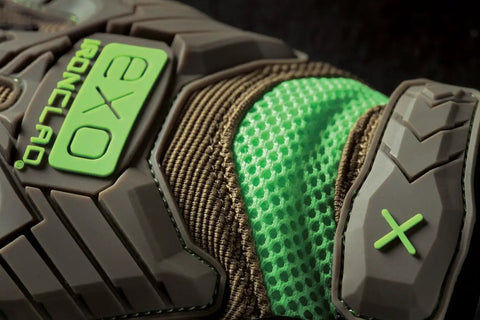 Close-up of Exo Motor Impact Glove showing TPR impact protection details in brown and green, size XL for heavy-duty work.
