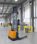 Powerful 3300 Lb Capacity Electric Pallet Stacker With Drive And Lift Features adjustable forks in a warehouse setting.