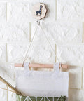 Over door hanging shoe organizer bag crafted from soft cotton linen with wooden frame, perfect for bedroom, bathroom, and garage.