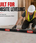 Man using 40 60 80 Inch Aluminum Spirit Level for jobsite leveling in construction setting.