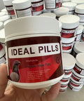 Hand holding bottle of Plant Based Pigeon Health Tablets For Palomas Breeding And Recovery Safe Herbal Pills 300 And 600 Count