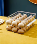 Two Layer Ramp Type Auto Rolling Egg Holder For Fridge Organizer Large Clear Egg Bin Stackable on kitchen table.