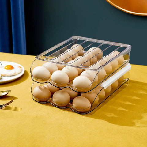 Two Layer Ramp Type Auto Rolling Egg Holder For Fridge Organizer Large Clear Egg Bin Stackable on kitchen table.