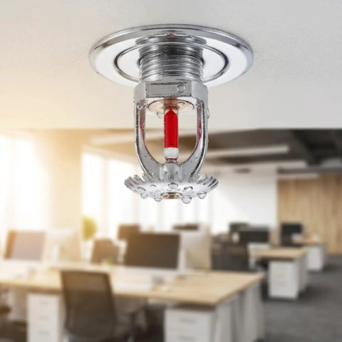 Heavy Duty 10 Pack Fire Sprinkler Heads Boasting 155F Upspray Shield And Straight Up Smooth Plug In Half Inch Threads For Any House Or Garage Guaranteed To Lock In Your Family Security With No Sweat Setup Every Single Time - 155F fire sprinkler head with copper threads and red indicator in an office setting.