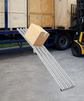 Foldable Gravity Conveyor Roller Belt For Warehouse Use loading box onto truck, showing stainless steel ramp in operation.