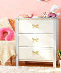 Brushed Gold Bow Dresser Knobs 4 Pack Large Decorative Cabinet Drawer Pulls for Girls Bedroom and Nursery Decor Two Size Options 2.76 by 1.57 Inches or 1.6 by 0.8 Inches Includes 3 Screw Lengths and Washers on white dresser in pink room