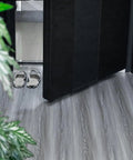 Real Wood Look Vinyl Floor Roll Featuring Dead Simple Peel And Stick Setup Super Wide Layout For Quick Room Makeovers Non Slip Grip and Totally Slick Resilient Surface For Heavy Daily Traffic laid out in an entrance area with slippers.